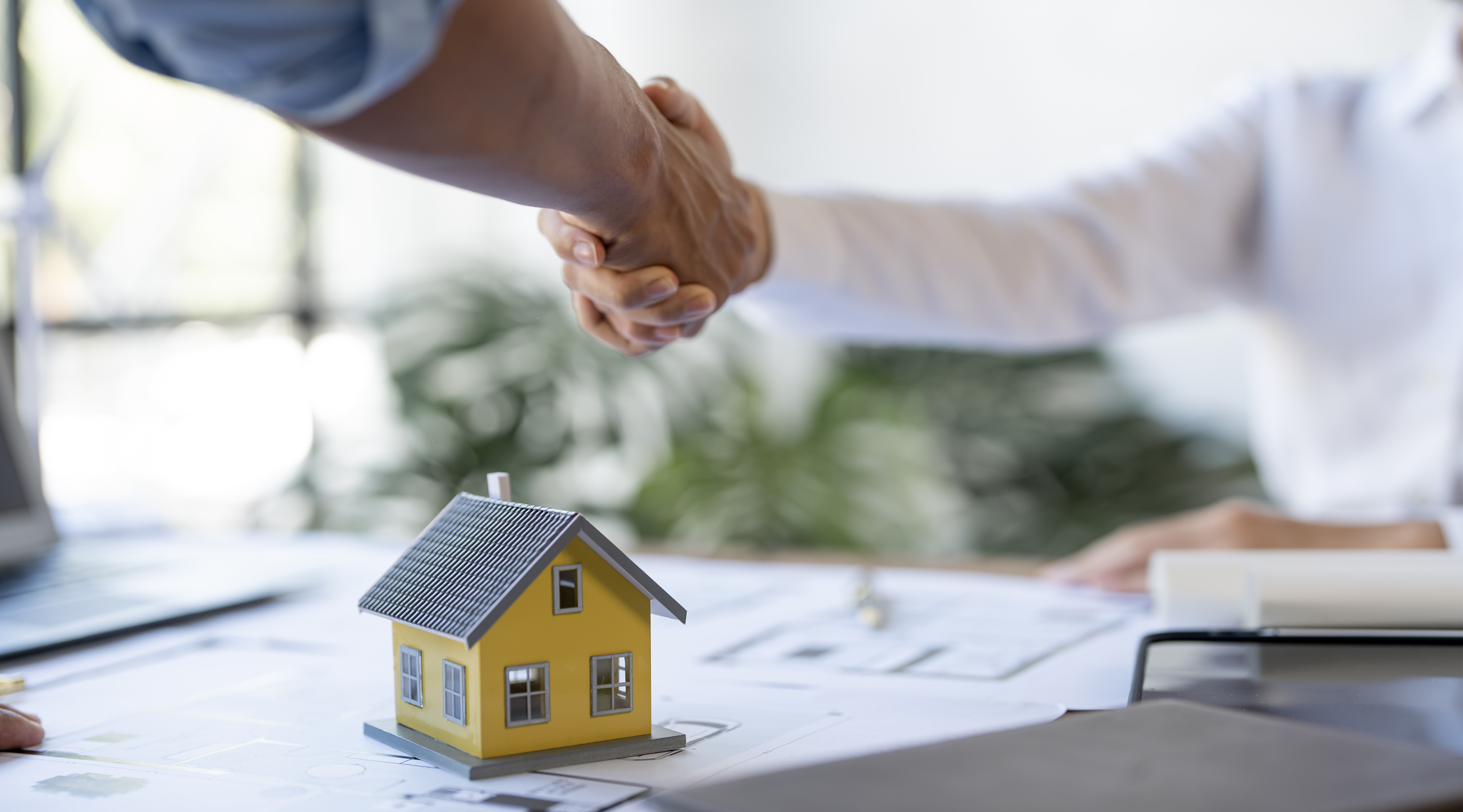 Buyers and real estate agents have agreed to buy or sell new house, businessman handshake